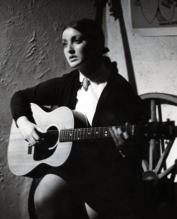 The photograph from which the halftone reduction of the newspaper cutting above was produced. Much more detail is visible than in the newspaper cutting: the young woman has classically 1960s makeup, with pale lipstick, and eyes outlined in black. Her hair is pulled back into a thick ponytail, and she wears a white high-necked blouse with a brooch at her throat.